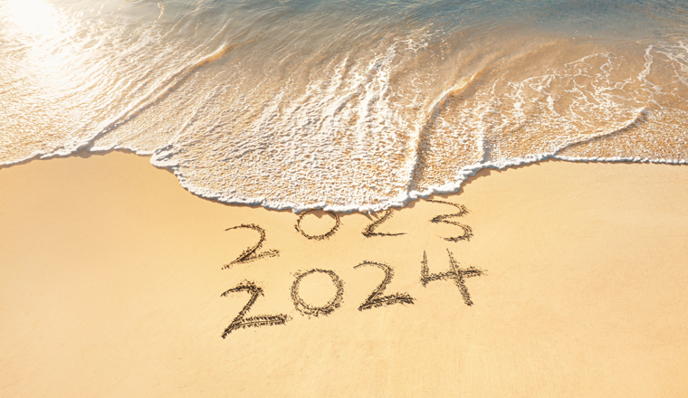 New year 2024 celebration on the beach,inscription 2023 and 2024 on sandy beach