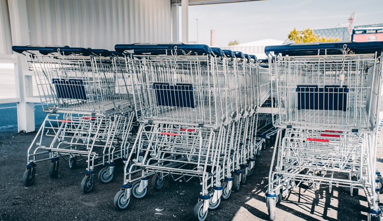 shopping carts. metal shopping carts at the back of a store. shopping car row at a supermarket