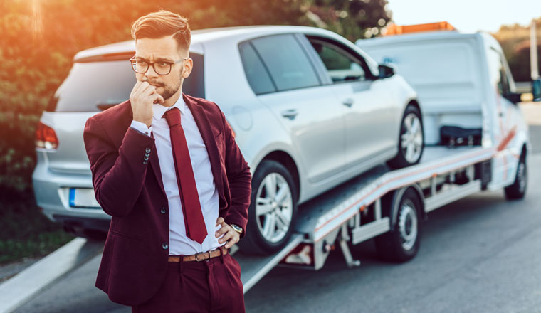 Elegant middle age business man using towing service for help car accident on the road. Roadside assistance concept.
