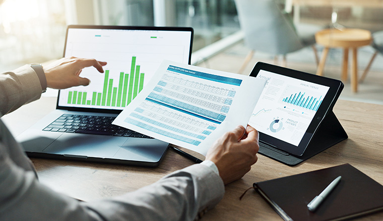 Hands, laptop and chart with paper for business man, analysis or check progress of economy, investment or profit. Financial agent, pc and reading graph for data document, growth or numbers for future.