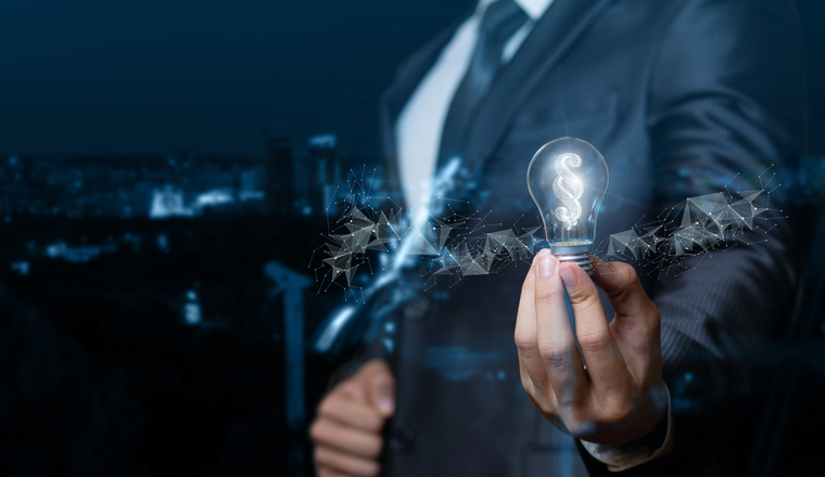 A lawyer or businessman showing light bulb burning inside the paragraph on blurred background.