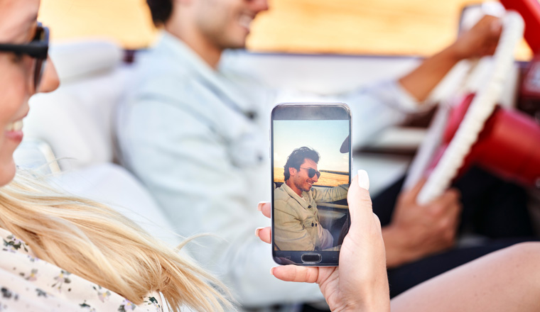 Woman making a selfie of her man during road trip