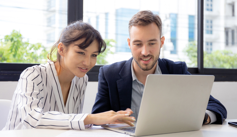 Young caucasian businessman is entrepreneur training businesswoman working confident together at office, manager and employee discussing and using laptop computer, two people, business concept.