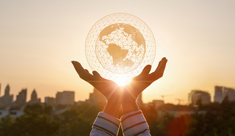 Concept Global network connection. Hands show network on the background of the city.