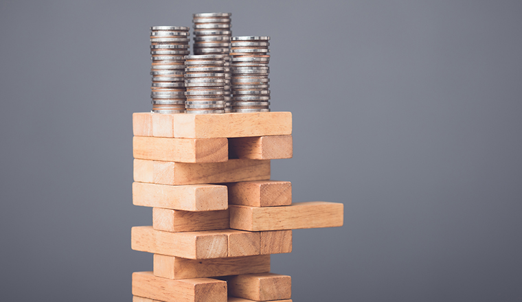 Risks in business or financial concept. Idea to prevent risk in business. Business man playing and selective right or risky piece of tower wooden block game and prevent falling down. Studio shot.