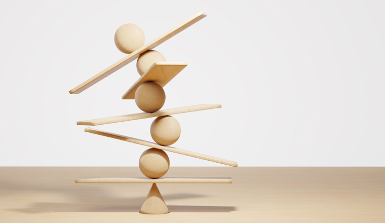 Wooden spheres balancing on seesaw. Concept of harmony and balance in life and work