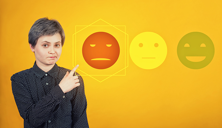 Doubtful skeptical woman pointing forefinger, disappointed face expression, choose negative feedback rating for bad customer service. Press on the sad face emoticon. Dissatisfied client survey symbol.