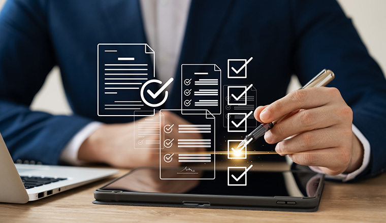 Business performance monitoring concept, businessman using tablet and laptop Online survey filling out, digital form checklist, blue background.