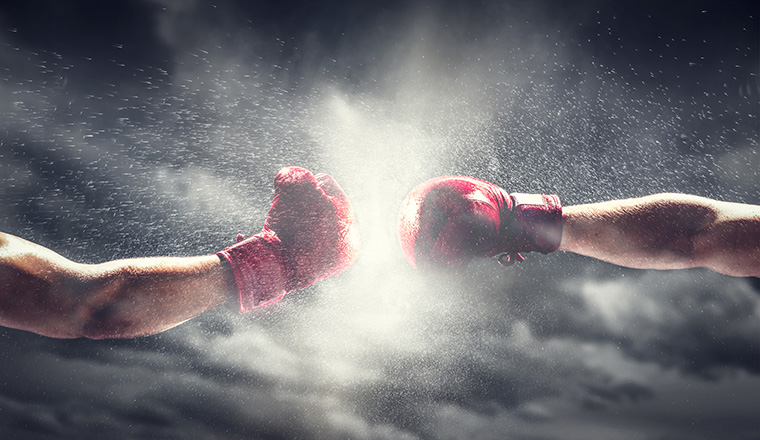 Two boxing gloves punch. Light on cloudy sky. Box, power, fight symbols.