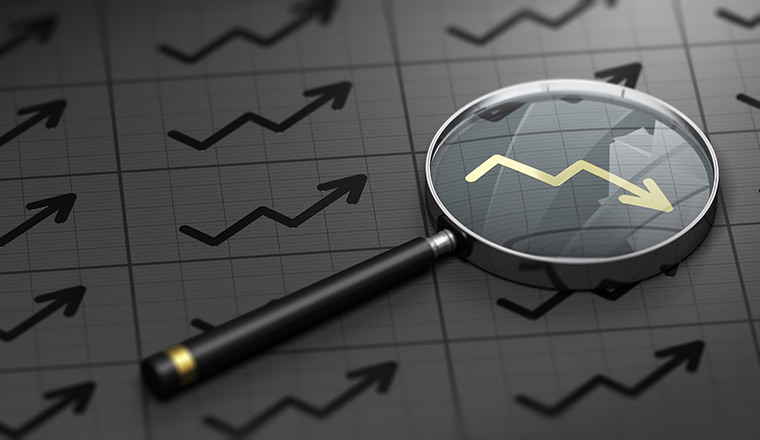 3D illustration of a magnifying glass over black background and golden decreasing chart symbol. Concept of brokerage.