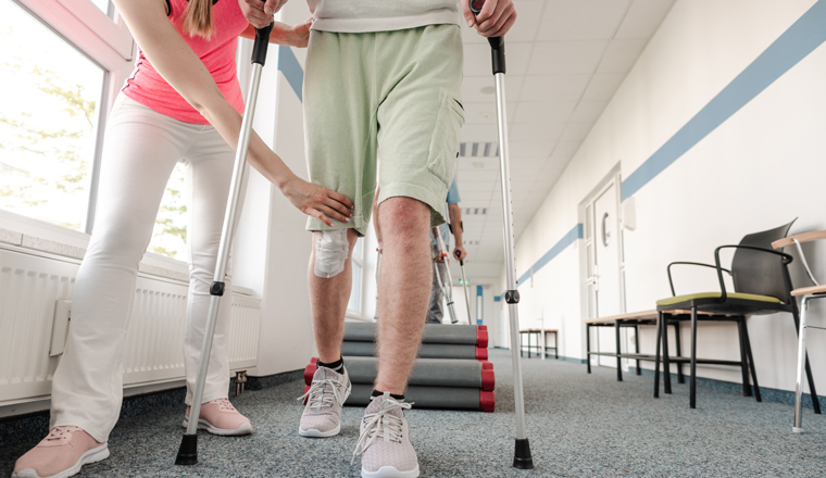 People in rehabilitation learning how to walk with crutches after having had an injury