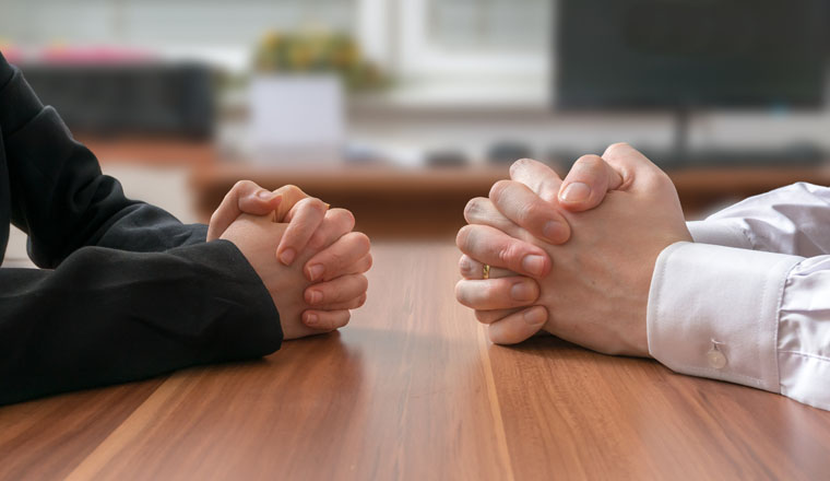 Interview or dialogue between politicians. Negotiation of two statesman with clasped hands in office.