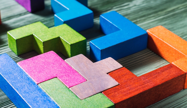 The concept of logical thinking. Geometric shapes on a wooden background. Tetris toy wooden blocks.