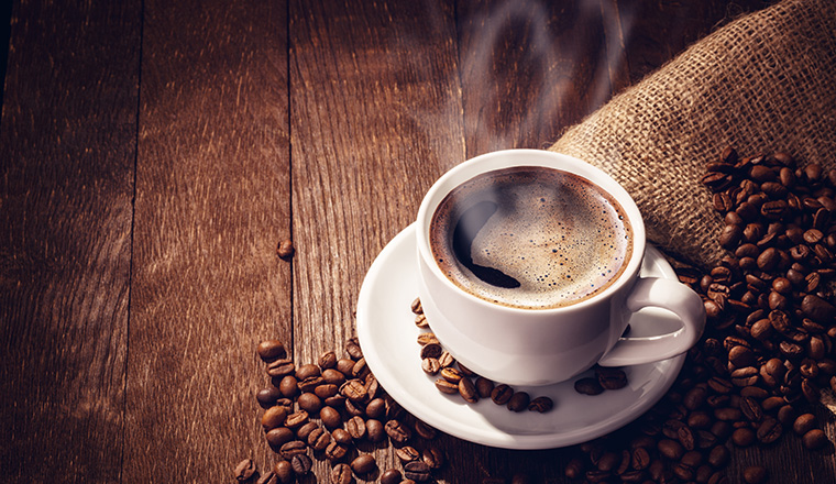 Cup coffee beans wooden dark background