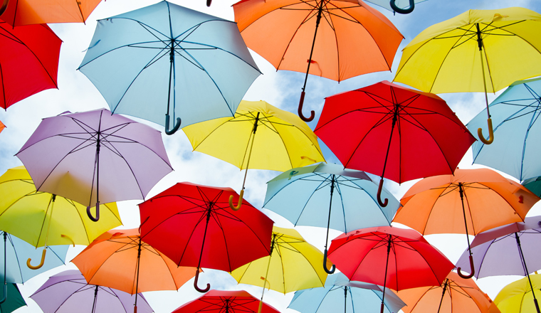 Bright colorful hundreds of umbrellas floating above the street