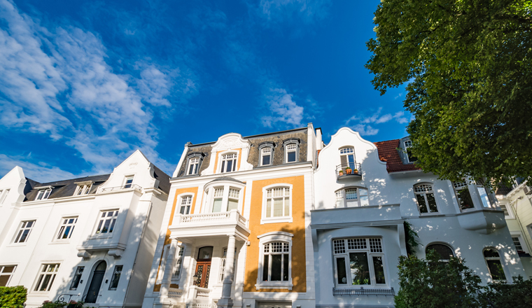 Luxury old mansions in Winterhude neighbourhood against blue sky on a sunny summer day, image for real estate agent business, realtor blog, magazines