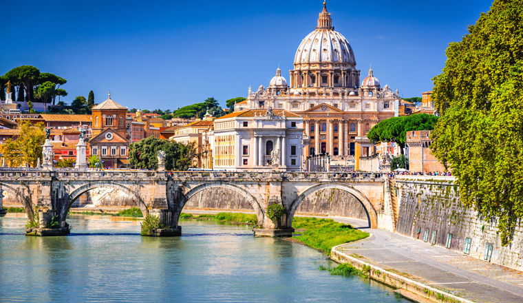 Rome, Italy. Vatican dome of Saint Peter Basilica (Italian: San Pietro) and Sant'Angelo Bridge, over Tiber river.