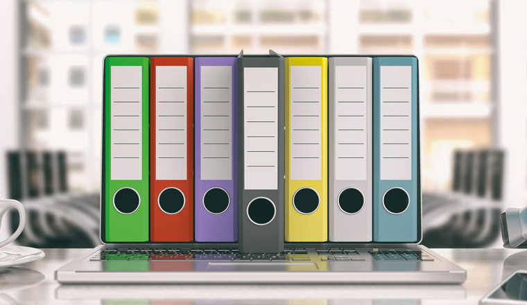 Colorful ring binders out of a laptop screen in an office. 3d illustration