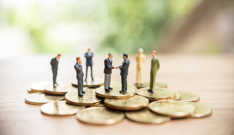 Miniature people standing on coin,Business concept