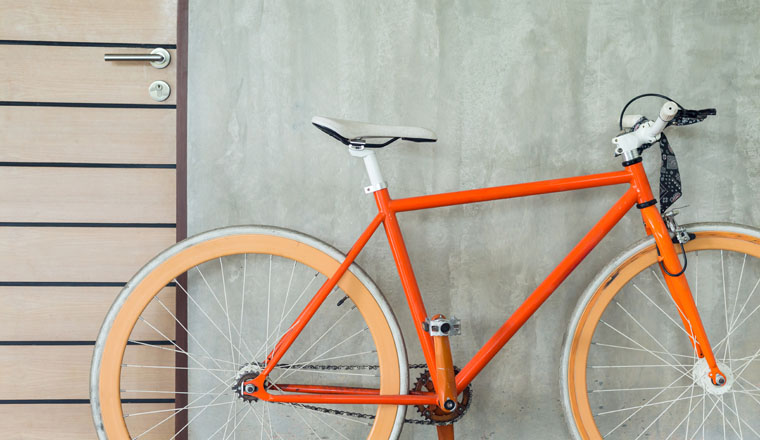 orange bicycle parked decorate interior living room modern style with cement mortar wall background