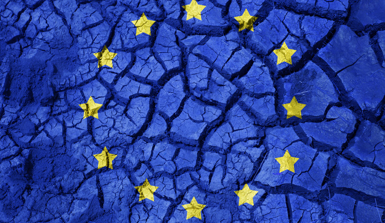 policy, crisis and national security concept - flag of europe on cracked ground background