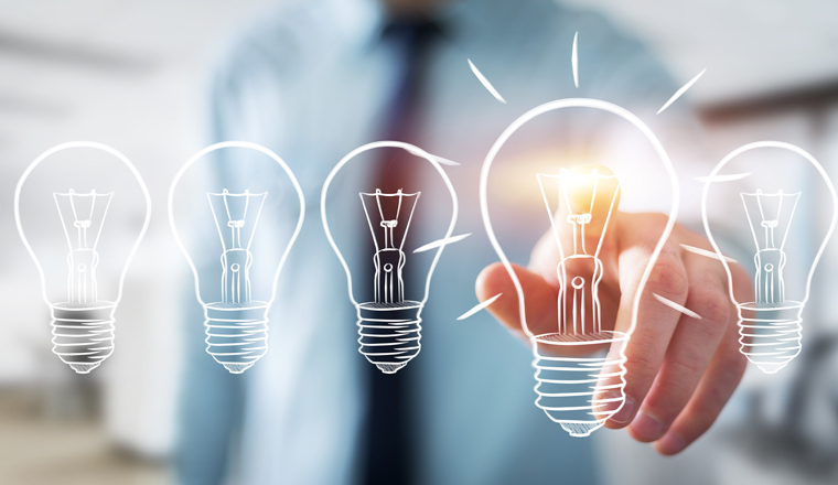 Businessman on blurred background touching a sketch lightbulb