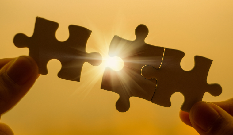 Silhouette Woman hands connecting couple puzzle piece against sunrise effect, businesswoman holding jigsaw with sunset background. Business solutions, target, success, goals and strategy concepts