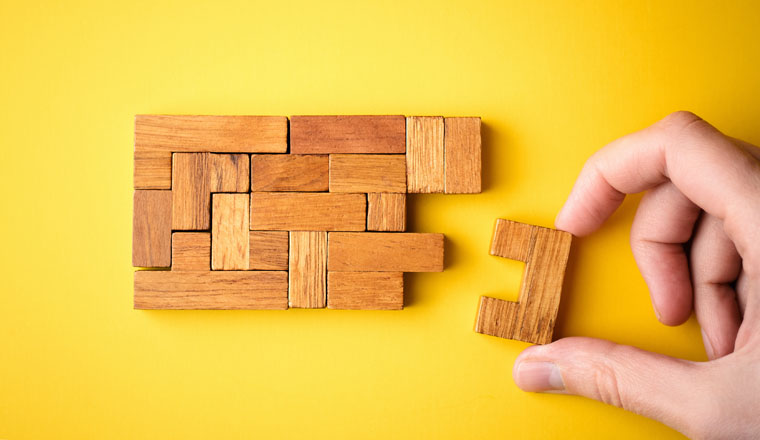 woman hand put wooden blocks arranging stacking for finishing task. Concept of solve problem and success plan.