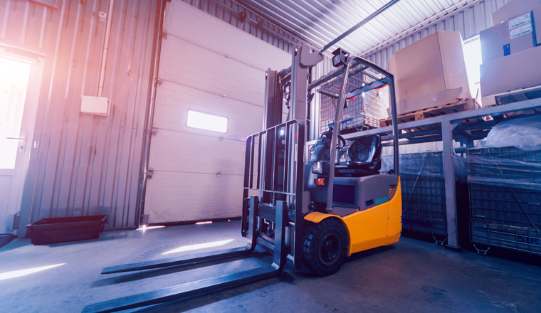 Forklift loader. Pallet stacker truck equipment at warehouse. Background