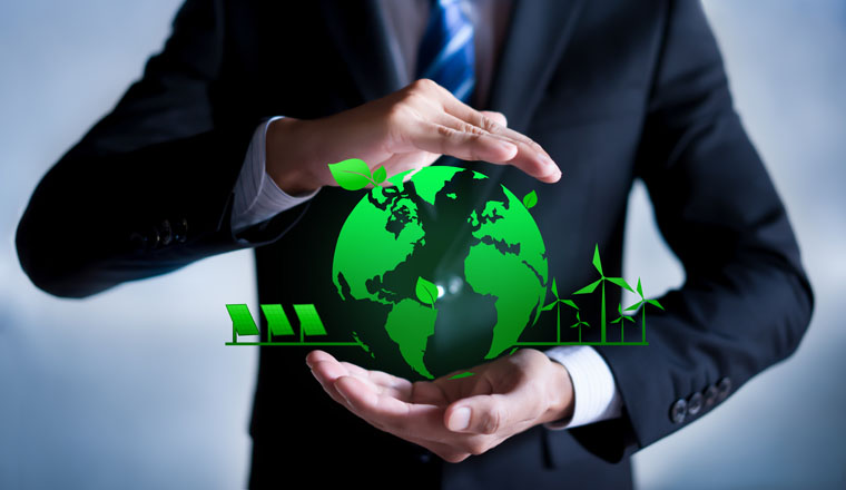 Businessman with a green globe. eco-friendly business. Business and environmental concepts