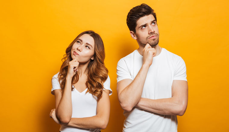 Image of happy young people man and woman in basic clothing thinking and touching chin while looking aside isolated over yellow background