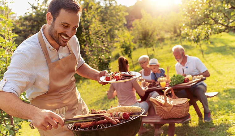 Happy family having barbecue party in backyard.Food,family,fun and happiness concept.