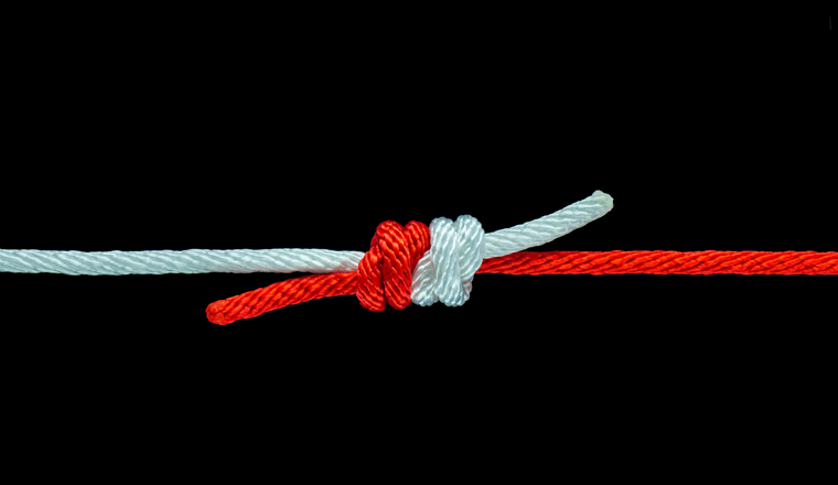 Tie the knot with red and white rope on black background