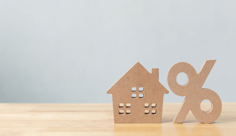 Percentage and house sign symbol icon wooden on wood table with white background