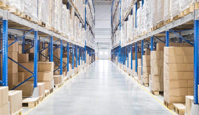 Passageway in a huge distribution warehouse with high shelves. Bottom view.