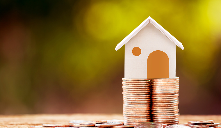 Loan or saving money for buy a house and real estate for family concept, Home model put on the stack coin tower with growing business investment in the in the public park.