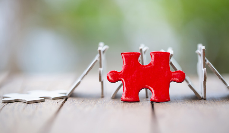 piece of Red   jigsaw puzzle On the old wood. teamwork concept.  symbol of association and connection. business strategy.