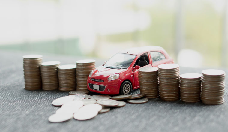 red car over a lot of stacked coins