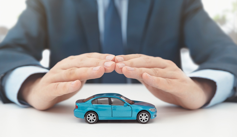 Car insurance, protection and safety concept. Insurance agent protects car with hands.