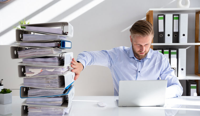 Businessperson Pushing Paper Documents Away And Working With Digital Documents On Computer Instead