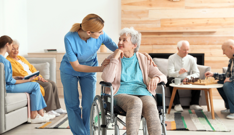 Nurses assisting elderly people at retirement home