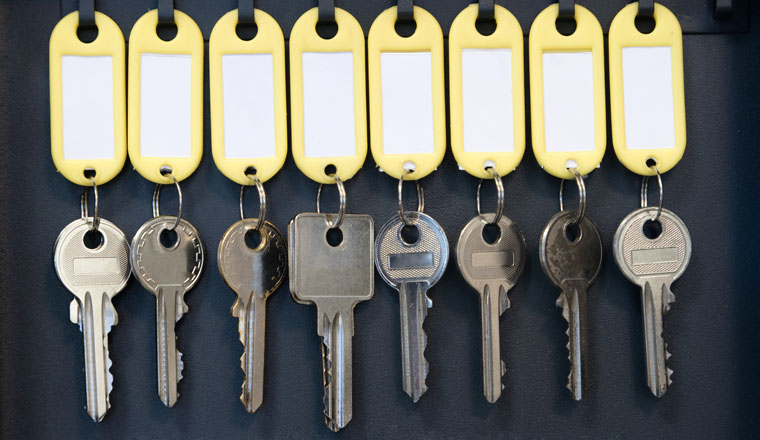 Hanging keys in metal cabinet for safety office or household keys management and keeping. keys with blank name tags, space for text