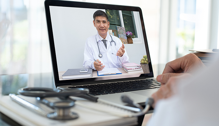 Doctor on video conference or teleconference, dicussing on case study via laptop computer in doctor room. Medical student studying with professor on internet channel. Telemedicine concept