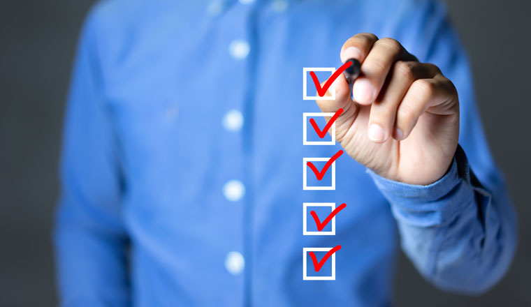 Checklist concept, Businessman checking mark on the check boxes with marker red