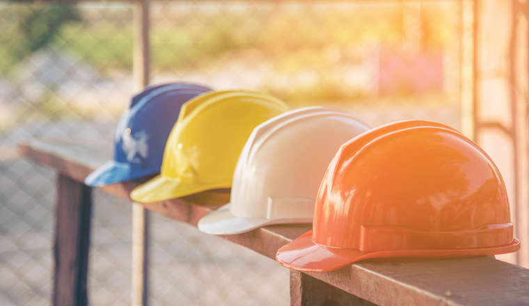 Construction hard hat safety tools equipment for workers in construction site for engineering protection head standard. Many hard hat helmet on row with copy space. Engineering Construction Concept