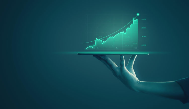 Businessman holding tablet and showing holographic graphs and stock market statistics gain profits. Concept of growth planning and business strategy. Display of good economy form digital screen.