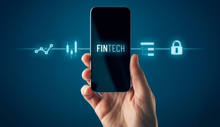 Fintech (financial technology) on smart phone concept. Hand with smart phone and text fintech and financial icons.