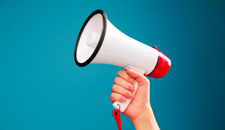 Picture of hand with mouthpiece on empty blue background in studio