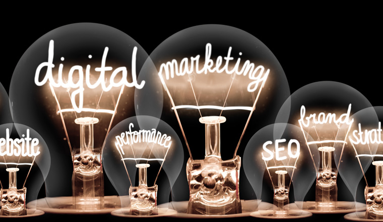 Photo of light bulbs with shining fibers in a shape of Digital Marketing, Website, SEO and Strategy concept related words isolated on black background