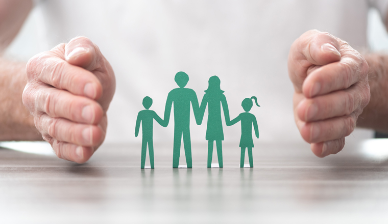 Family protected by hands - Concept of life insurance